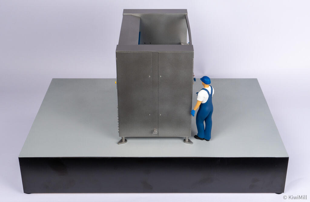 Elevated end view of the belt chiller model with the operator figure at the corner and blue belt visible above